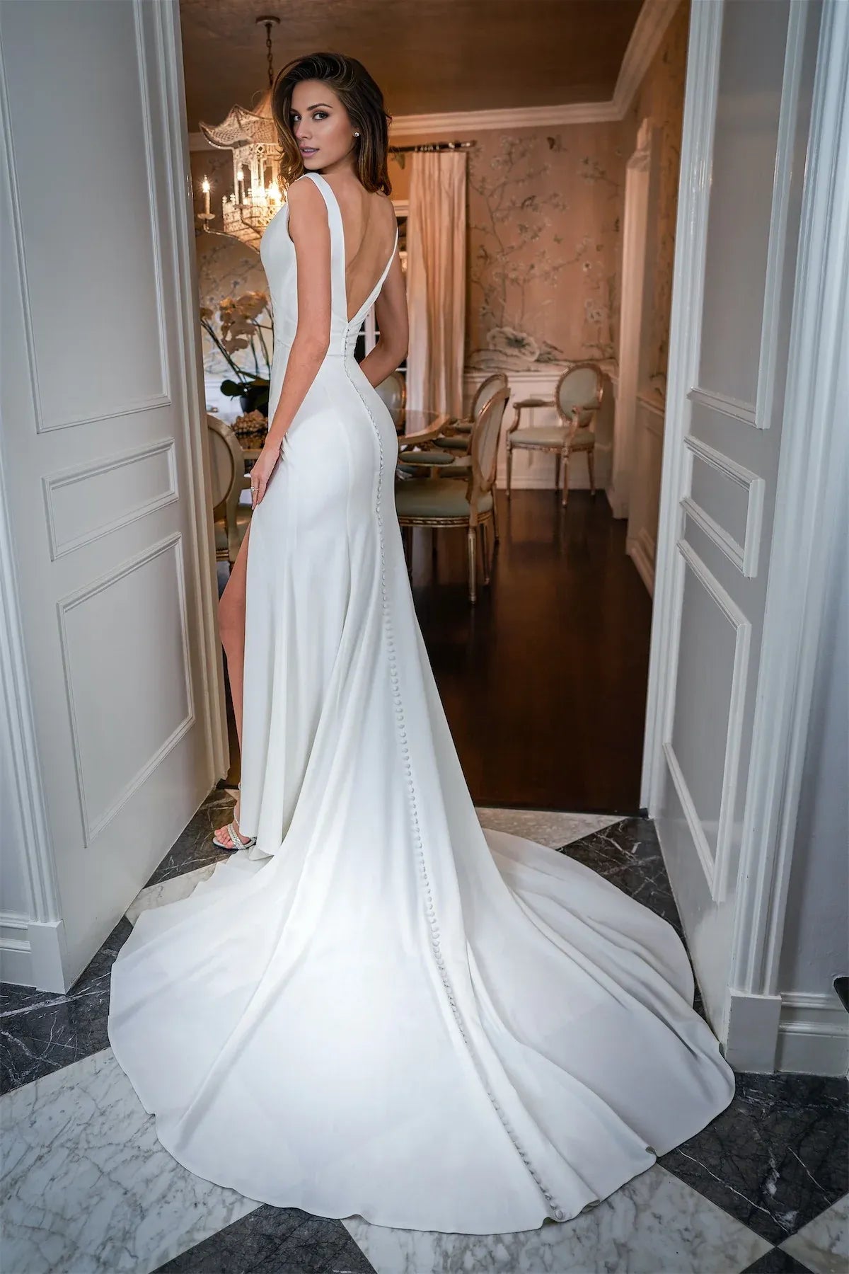 Sleeveless Plunging‑V‑Neck Crepe Mermaid Wedding Dress With High‑Slit & Pearl‑Button‑Back Detail