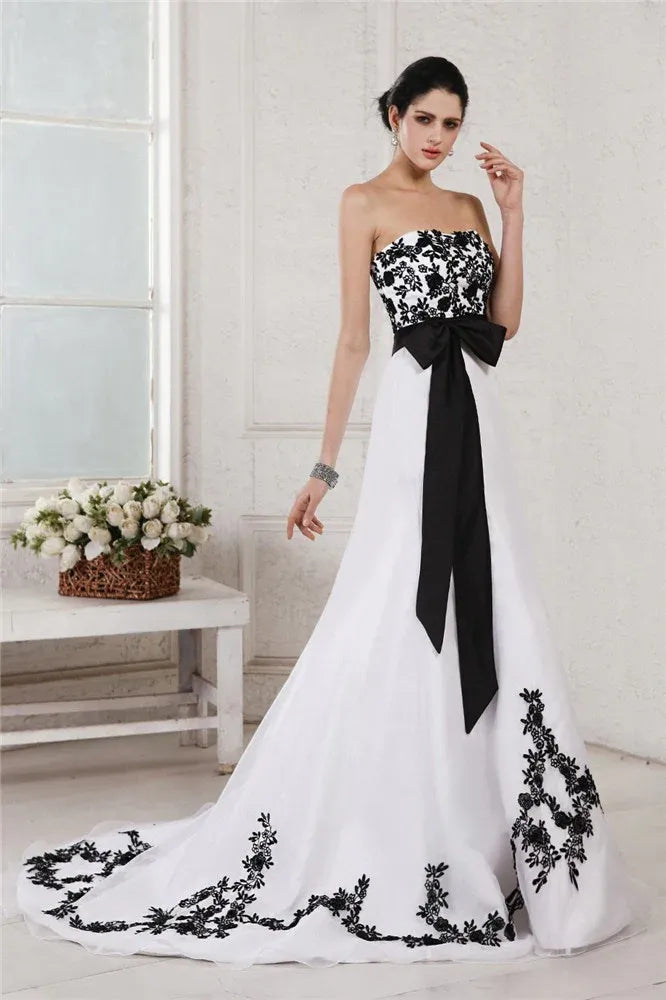 Strapless Black‑Lace‑Appliqué White‑Tulle A‑Line Wedding Dress With Oversized‑Bow Waist & Corset‑Back Detail