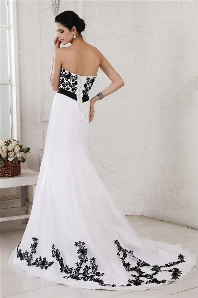 Strapless Black‑Lace‑Appliqué White‑Tulle A‑Line Wedding Dress With Oversized‑Bow Waist & Corset‑Back Detail